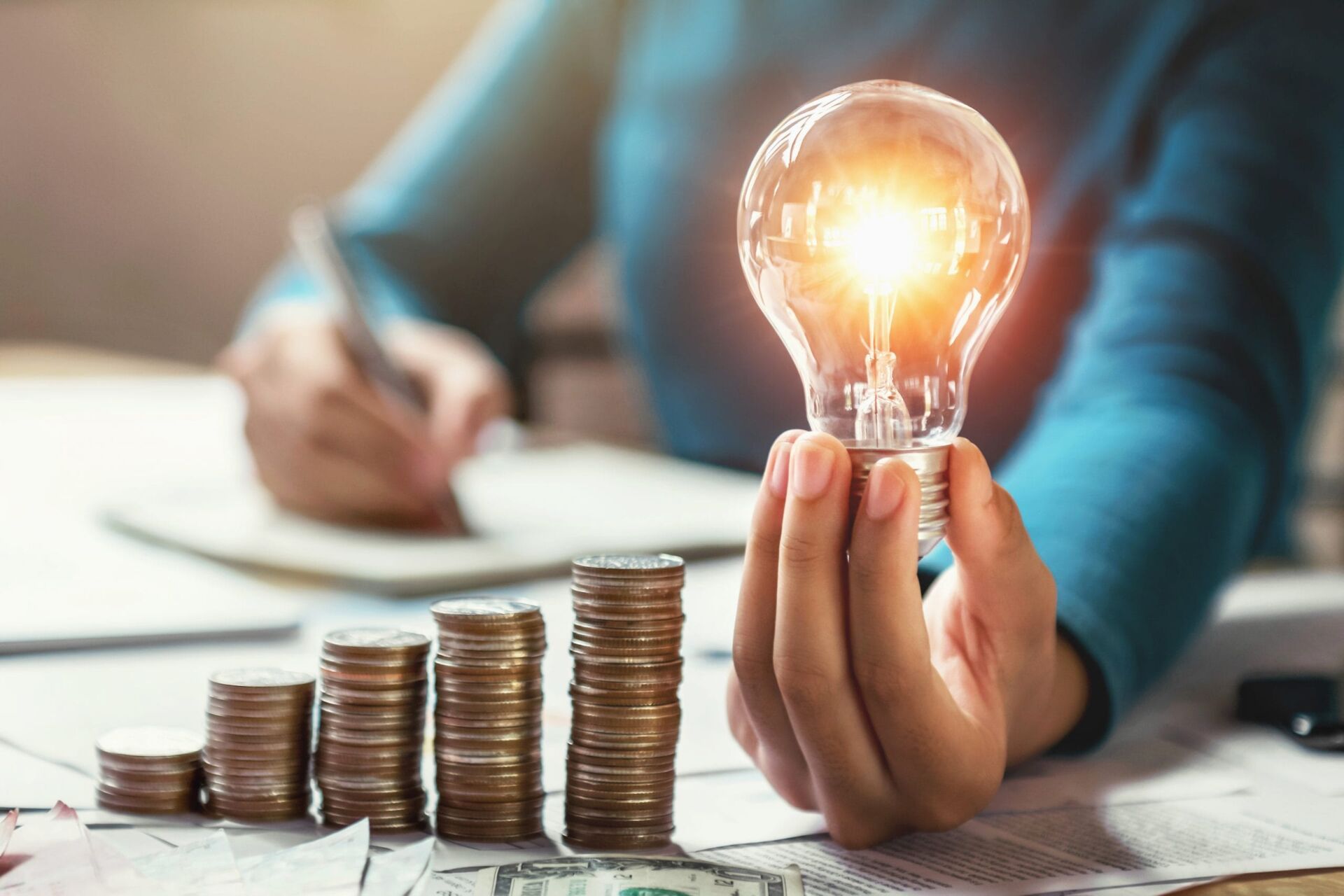 financial incentives concept with increasing coins and lightbulb