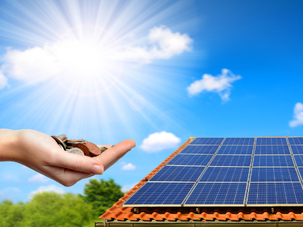 Solar Savings Money in Hand Solar Panels on Roof