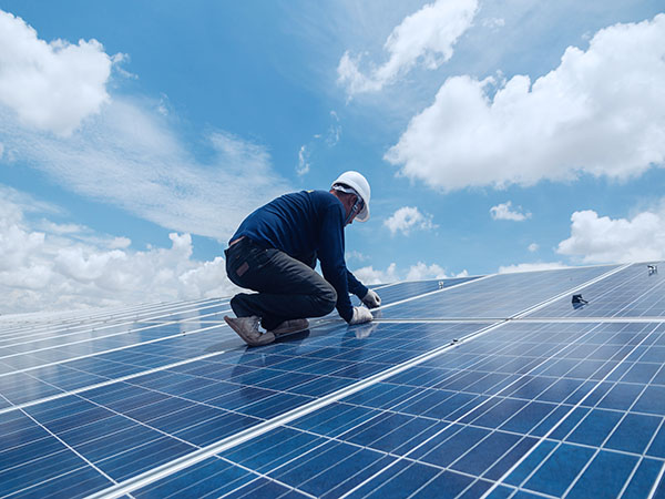 man working on solar panel