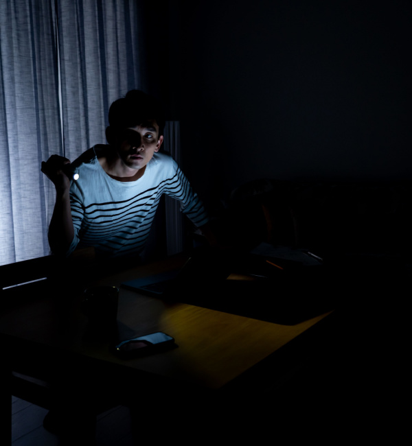 man sitting in a room during a power outage