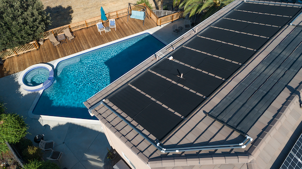 house with roof top solar overlooking pool