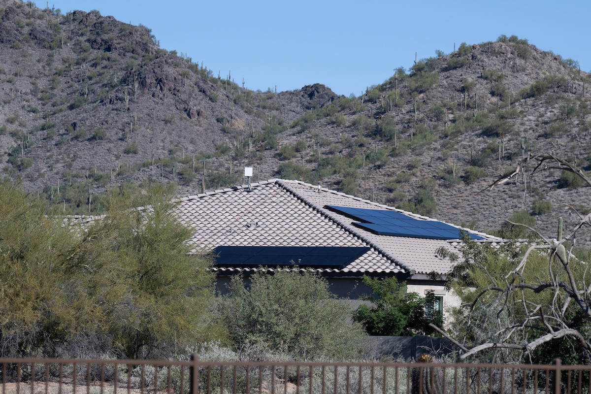 Arizona home nestled in the hills with solar panels on roof
