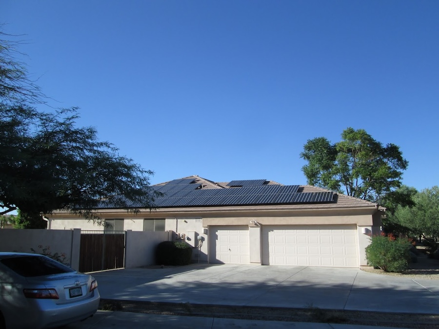 home on a clear sunny day with all black solar panels