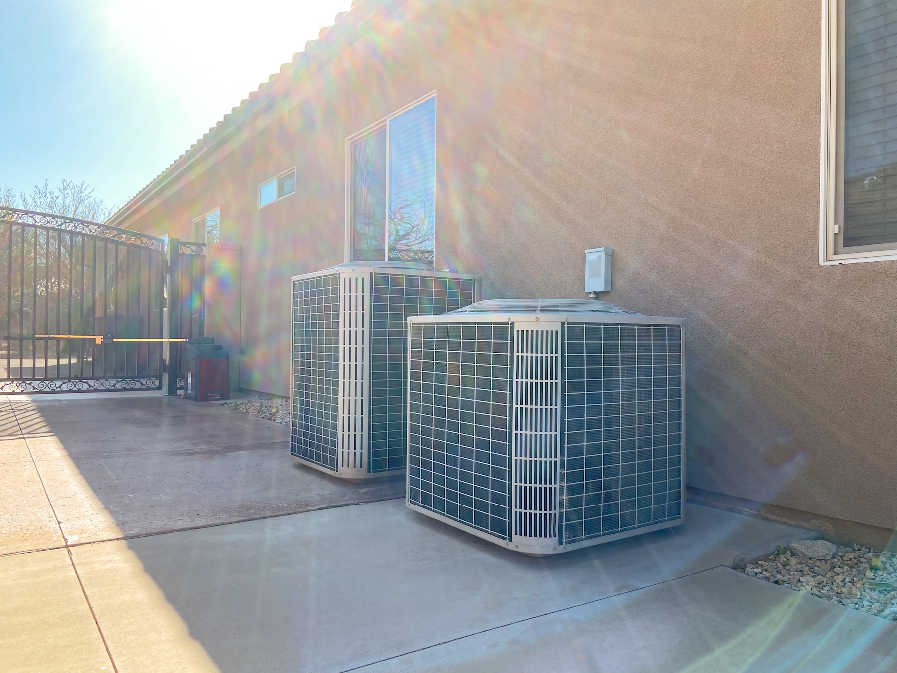 Double AC units on driveway on side of Arizona home with dryscape