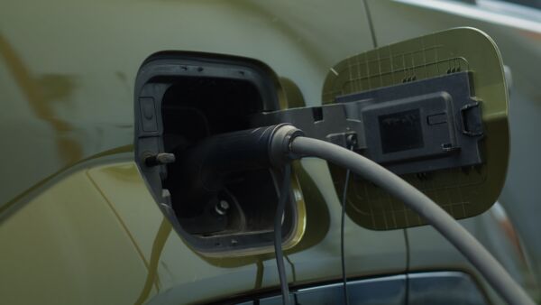 Close up of electric vehicle being charged on an at-home EV charger