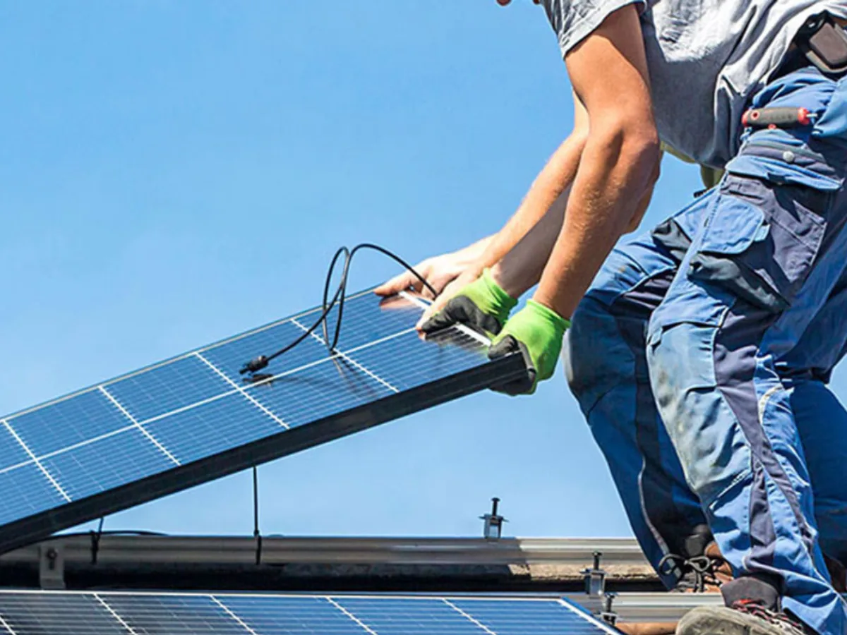 southface solar & electric team members lifting up a solar panel